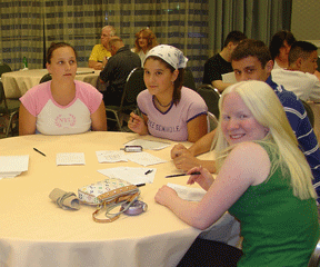 Teens socialize around a table