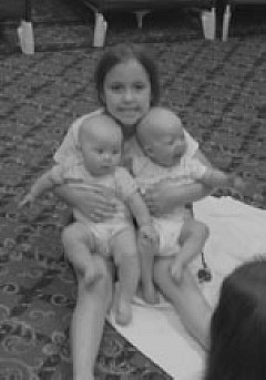 Rebecca, Laura, and Elizabeth Prows pose in the NFB Camp nursery