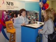 First Lady of the Federation, Pat Maurer, offers brochures and forms to Possibilities Fair attendees.