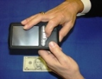 The Kurzweil-National Federation of the Blind Reader (KNFBR) identifies a five-dollar bill.