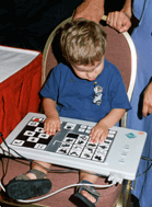 Young child learning a new piece of adaptive technology.