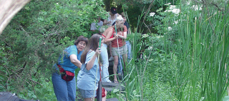 Mentees and mentors go for a nature walk with their canes helping to guide them