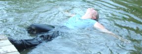 A mentor floats in the water during an activity.