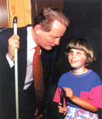 Marc Maurer with a blind child.