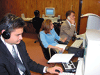 Several young blind people working on computers with access technology.