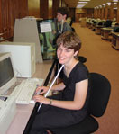 A young blind girl works on the computer.