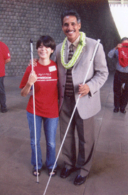 Brook Sexton gives Hawaii Lieutenant Governor James "Duke" Aiona a cane travel lesson.
