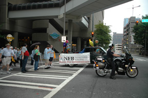 A motorcycle policeman and the sound truck led the way as marchers returned to the hotel.