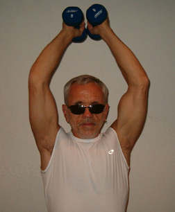 Robert Leslie Newman is five feet, eight inches tall and weighs 152 pounds. He is pictured here in exercise clothes, raising hand weights.