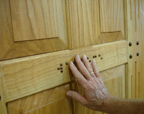 The word �welcome� is written in Braille at the center of this magnificent door. James Mays�s hand reading the word provides perspective.
