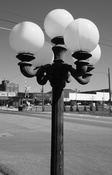 A wrought iron lamppost .