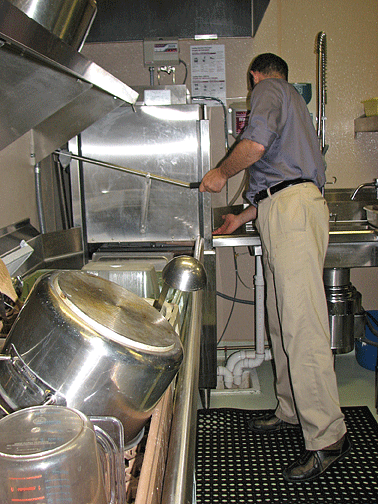 Frank Dyer operates the new dishwasher.