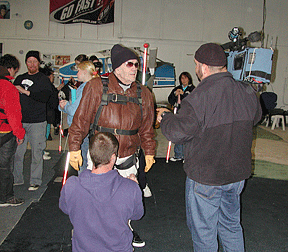 Robert Willis, age seventy-nine, is being interviewed by WWMT Kalamazoo, channel 3, as a skydiving instructor adjusts Mr. Willis&rsquo;s chute harness. Photo courtesy of the Michigan Commission for the Blind