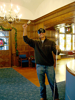 Harrison Hoyes rings the freedom bell at the desk in the lobby.