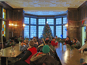 Everyone gathers at 8:00 a.m. for announcements, roll call, the word of the day, and a joke to send folks to class laughing. To the left are the leaded stained glass windows, and to the right is the hall to the kitchens.
