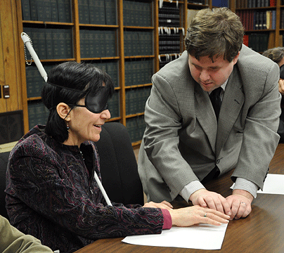 Tony Olivero, access technology specialist in the International Braille and Technology Center, served as assistant instructor during the February 5 session of the NFB-sponsored Transformational Seminar conducted for students of the 2009 class of the Greater Baltimore Committee Leadership Program. Here Tony teaches Braille to Suzanne Sangree, chief solicitor for the City of Baltimore.