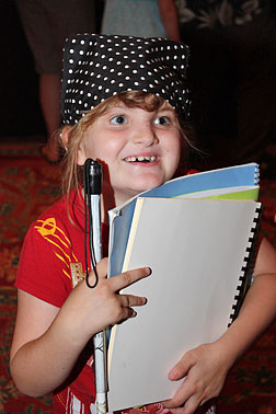 Anna Walker is obviously delighted with her stack of Braille books. 