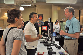Captain Ivan Castro talks about technology with Mike May while his wife listens.