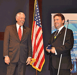 At the closing ceremony of Slam 2009 Mark Riccobono, executive director of the NFB Jernigan Institute, presented a Louis Braille Bicentennial Silver Dollar to Steny Hoyer, majority leader of the U.S. House of Representatives.