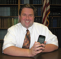 Tony Olivero demonstrates the use of an iPhone.