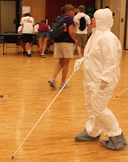 A student walks around in her forensic suit.