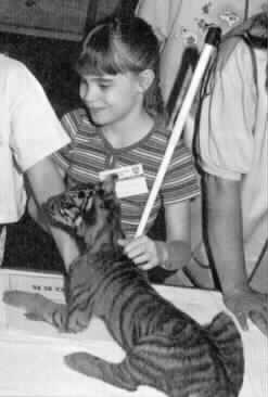 Nikki Zimmerman pictured
with a young cougar.