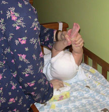 Mother changing her baby