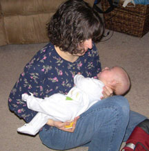 A blind mother holds her baby