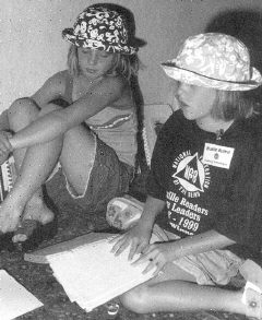 Madison and Macy McClain are pictured reading a book together. (20917 bytes)