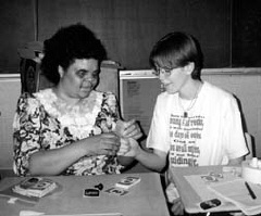 Mary Kuforiji shows a student how to insert a card into the slate.