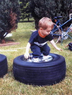 Jason Polansky (age 2, Thurmont, MD) is using a free play opportunity to stimulate his mind and exercise his body.