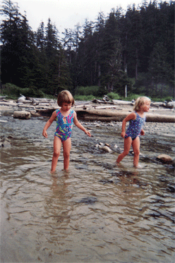 Kyra (left, age 3) and sister Kiko (age 5) play in a stream. It�s the beginning of a love affair with water sports for both of them.