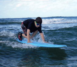 A �totally stoked� Vejas prepares to ride a wave.