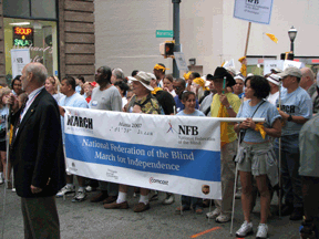 Several people hold the banner announcing the March for Independence.