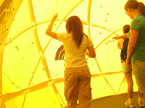 Students explored the universe in unique and fully accessible ways at the NFB Youth Slam. In this picture, students navigate through the world�s only tactile planetariums.