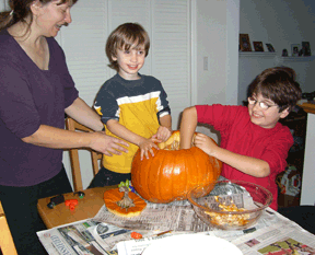 Rasa, Petras, and Vejas participating in one of the more enjoyable �chores� of carving pumpkins for Halloween.