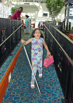 Dave Gill knows that he can let his daughter, Elora Garcia, run ahead because he knows that she can use her cane to travel safely.