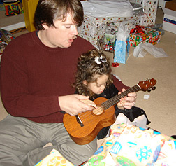 Richard Holloway and Kendra playing a ukulele.