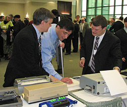 Steve Booth and Wes Majerus demonstrate technology to student Nijat Worley.