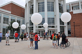 Operation Air Slam students prepare to launch their weather balloons to collect atmospheric data using the payloads attached to the balloons.
