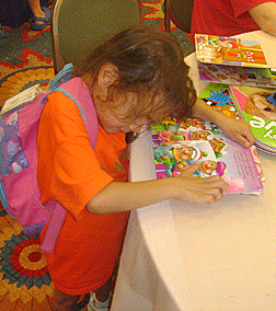What a find! Milagro gets into the spirit of the Braille Book Fair at the 2008 NFB Convention.