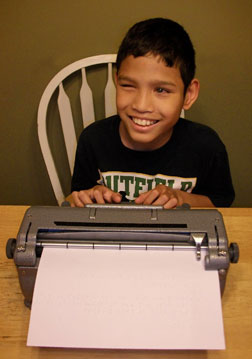Noah Mondor updates his contest log, using a Brailler