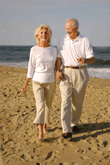 A couple get's their exercise in with a brisk walk on the beach.