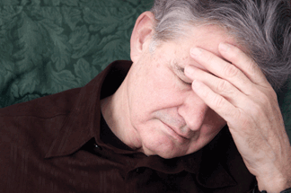 A man holding his forhead looking defeated.