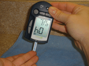 Figure 2 - Strip is pointing down and the notch on the end is touching the blood sample.