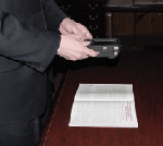 Man using K-NFB Reader to translate a book