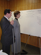 Steve Benson and his wife Peg take a moment to read donor names on the Wall of Honor display at the Grand Opening Celebration.