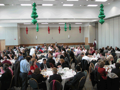 Conference delegates are pictured here assembled for the Thursday luncheon. Festive holiday decorations can be seen.