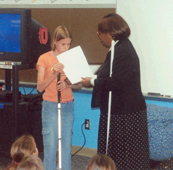 NFB Kansas City Chapter President, Ruby Polk honors, fifth grader, Holly Carneal.
