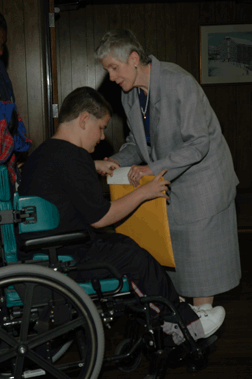 NFB of Maryland President, Sharon Maneki, congratulates Joshua Gregory as one of the nation's Braille Readers Are Leaders winners.